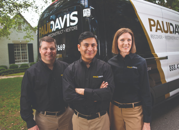 Paul Davis team in front of a van
